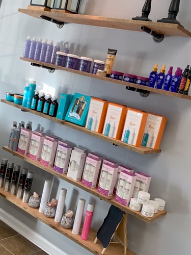 hair care products on wooden shelves in Salon Dior